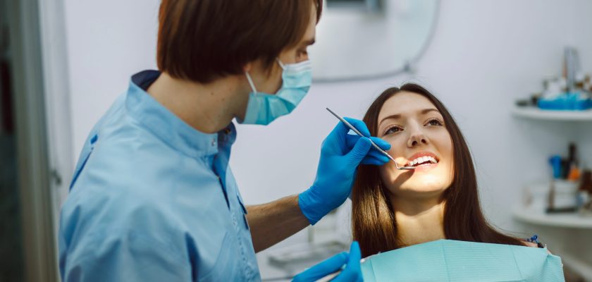 Assistant dentist and the patient in the clinic.